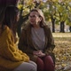 Caucasian women sitting together at bench in park in autumn. Shot with RED helium camera in 4K - VideoHive Item for Sale
