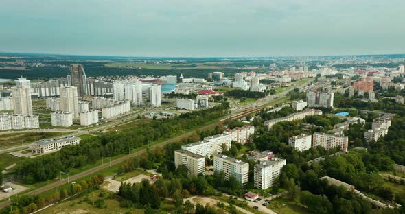 City in the daytime, multi-storey buildings and a large number of trees.