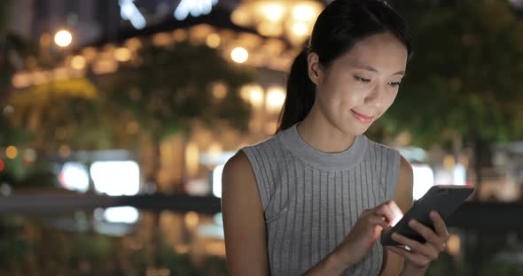 Woman using cellphone in the street at outdoor  alt
