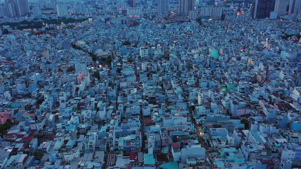 drone shot panning from left to right at twilight over densely populated and built up area of a mode alt