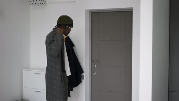 Black Man in Front Home Door Putting on Trendy Coat Leaving House Slow Motion alt
