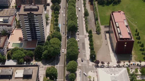 Cityscape buildings and wide street with traffic in San Sebastian, aerial drone view alt