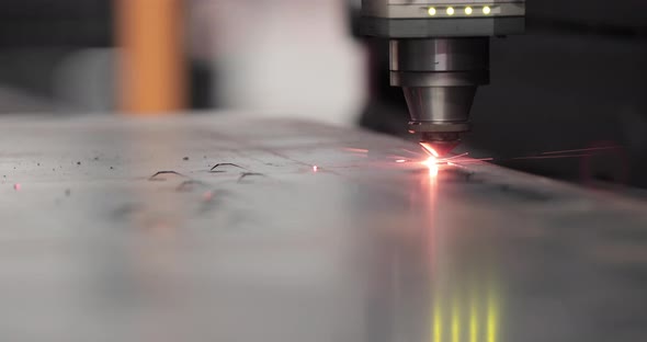 Tip Of Laser Cutter Cutting Stainless Sheet With Sparks