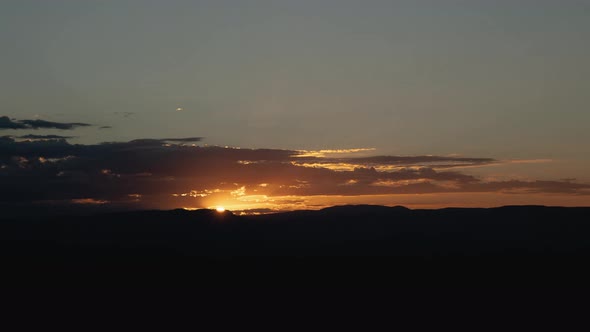 Golden Sunrise Behind Thin Layer of Clouds Timelapse Wide Shot