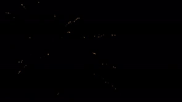 Shining Fireworks with Bokeh Lights in the Night Sky. Glowing Fireworks Show. New Year's Eve alt