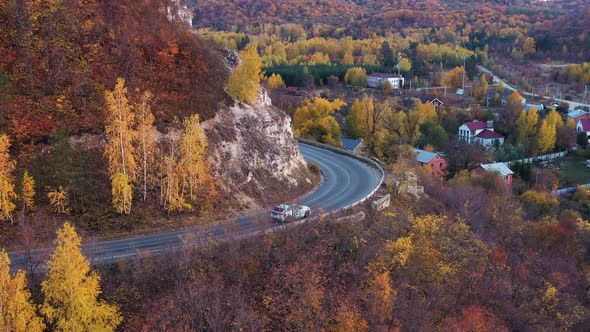 Curvy Mountain Road Near Village in Autumn