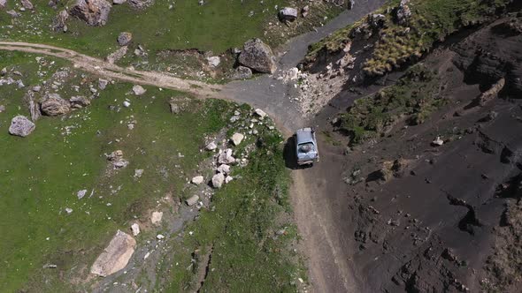 Drone Shot From Great Height of Multiple Suv Driving Through Convoluted Mountain Road in African