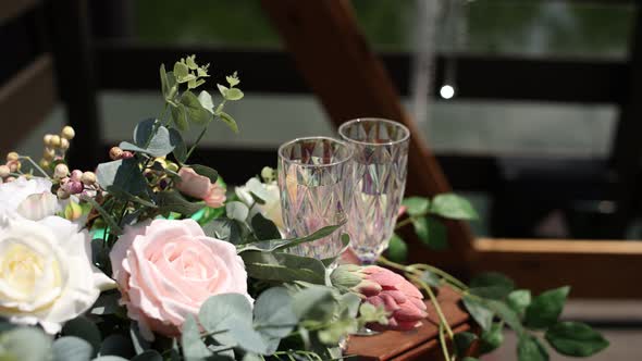 glasses with flowers near the wedding ceremony in summer