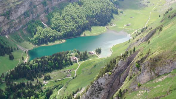 Drone shot of Seealpsee lake in the Alpstein range, Appenzell Alps, Switzerland alt