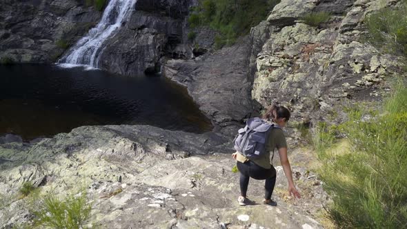 Woman hiking in Fisgas de Ermelo waterfall most beautiful in Portugal alt