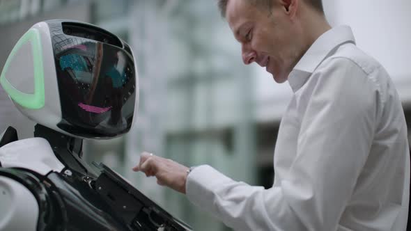 Electronics Engineer Working Scientist Inventor on Robot Construction alt