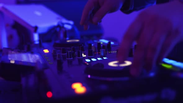 DJ Hands Controlling a Music Table