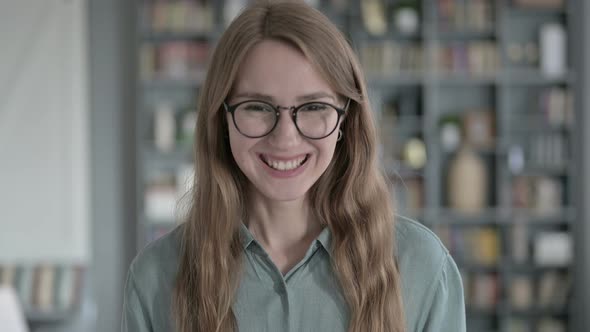 Portrait of Cheerful Woman Saying Yes By Shaking Head alt