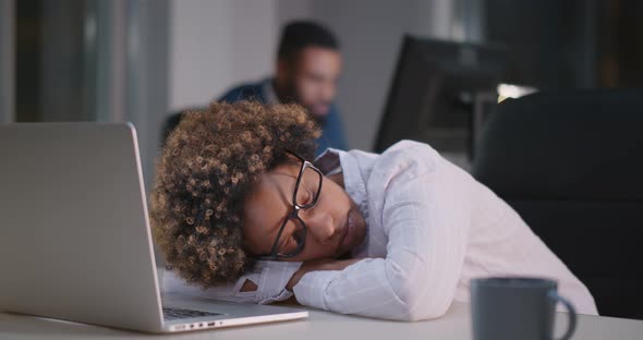 Exhausted Overload Black Businesswoman Falling Asleep on Desktop alt