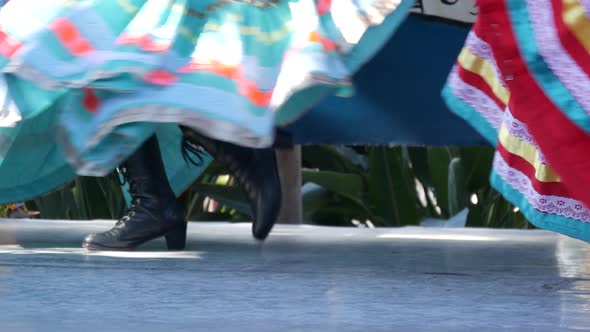 Latino Women in Colourful Traditional Dresses Dancing Jarabe Tapatio, Mexican National Folk Hat