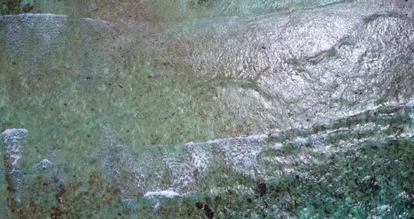 Wide angle overhead island view of a white sandy paradise beach and blue water background in best qu alt