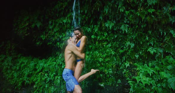 Couple Exploring Jungle Waterfall alt