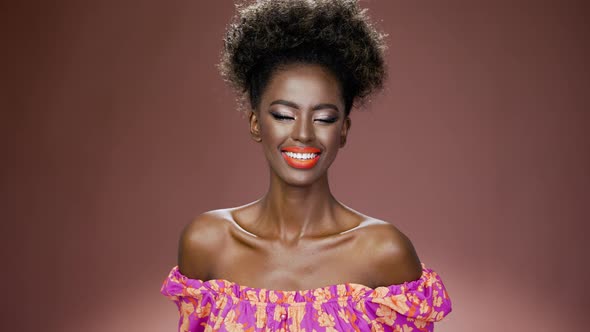 Smiling African Ethnic Young Woman with Colorful Fashion Makeup