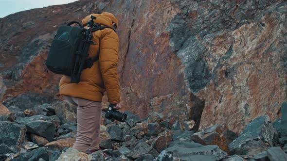 Man Hiker Taking a Photo on the Top of Forested Mountains alt