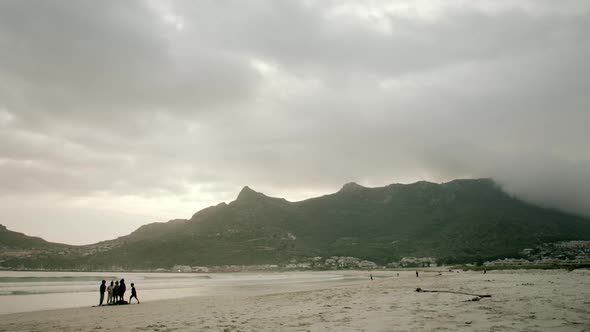 Locked shot of an empty beach at Hout Bay South Africa in the evening with cloudy sky and hazy mount alt