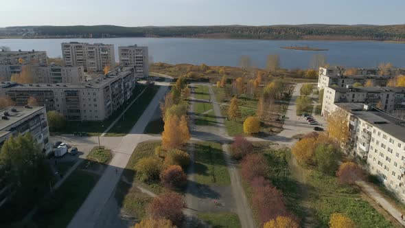 Aerial view of alley near the pond in a provincial autumn town 21 alt