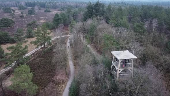 Flying with a drone over a lookout tower to spot wildlife in De Hoge Veluwe National Park in The Net alt