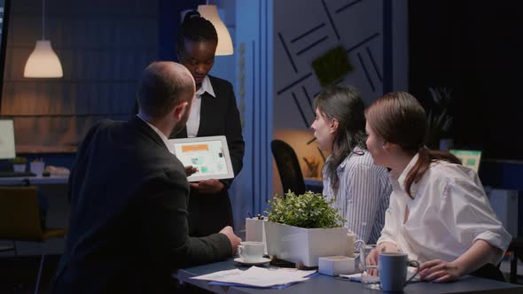 African American Businesswoman Showing Corporate Marketing Graphs Using Tablet alt