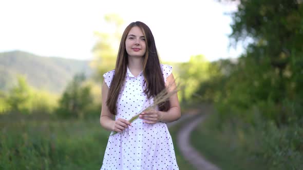 Pregnant Young Woman Walks Outdoors