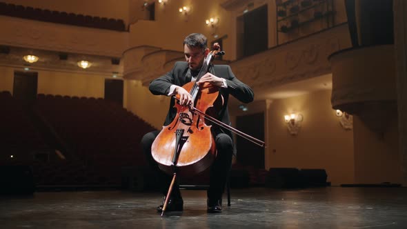 Solo of Violoncellist on Scene of Old Opera House Portrait of Cellist in Empty Philharmonic Hall alt