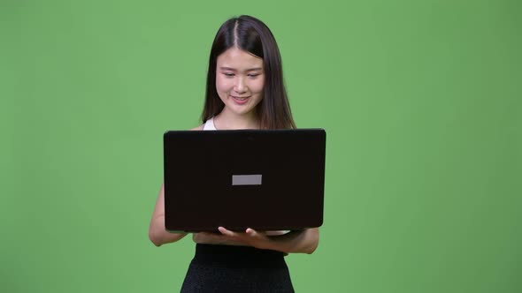 Young Beautiful Asian Businesswoman Using Laptop