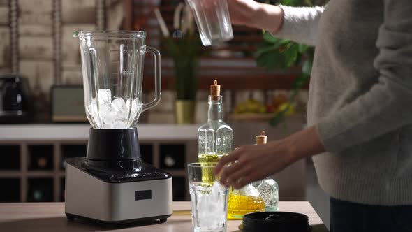 Woman Preparing Ice for Crushing in Blender alt