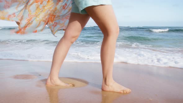 Playful Woman in Beach Dress Waving on Breeze Making Splashes White Foamy Waves alt