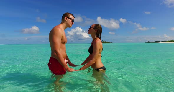 Young people on romantic honeymoon enjoy luxury on beach on clean white sand background 4K alt