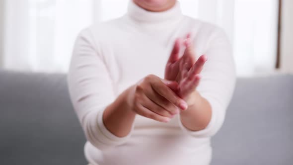 Detail of young woman performing moisturizing hand with moisturizer lotion in cream. alt