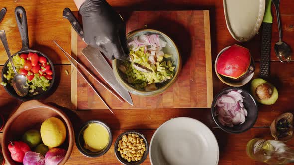 Preparation of Ceviche - table top view of a professional chef tossing and mixing fresh ingredients alt