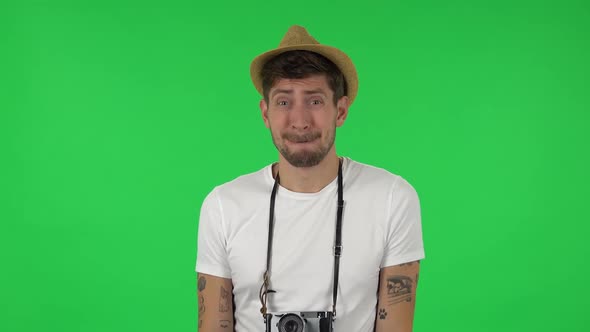 Portrait of Confident Guy Is Saying Oops and Shrugging . Green Screen alt