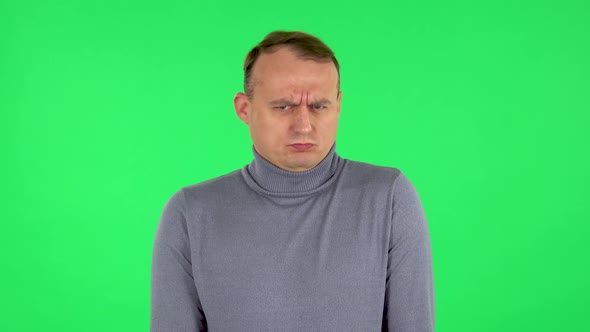 Portrait of Male Is Upset, Waving Her Hands in Indignation. Green Screen alt