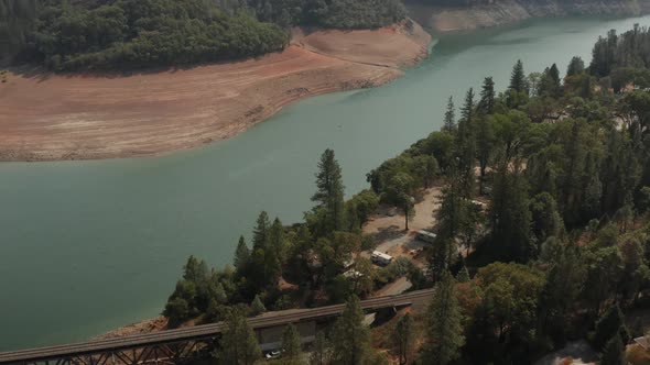 Aerial view of Shasta Lake Bridge in Northern California low water levels during drought alt