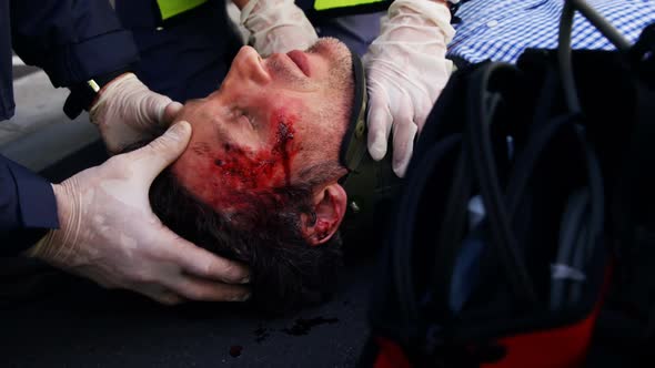 ambulance team taking care on his wounded person alt