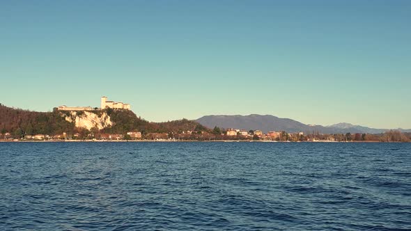 Zoom out view of Angera fortress on lake Maggiore hill, Italy alt
