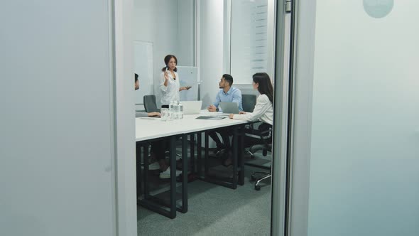 Young Indian Female Leader Manager Explaining Company Development Strategy to Diverse Colleagues at alt