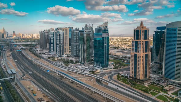 Aerial View of Dubai Marina Skyscrapers and Jumeirah Lakes Towers Timelapse with Traffic on Sheikh alt