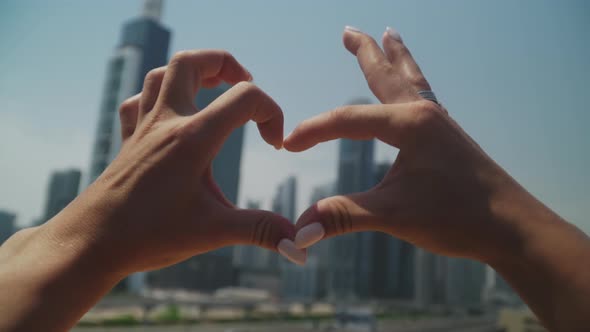 Women's Hands Show a Heart Sign alt