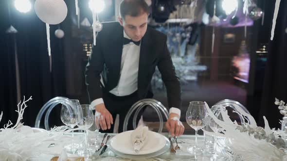 Waiter Arranging Table for the Christmas Party