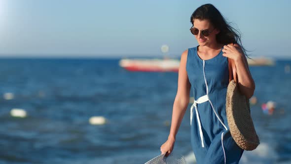 Relaxed Brunette Travel Woman Enjoying Walking on Beach at Sunset During Vacation alt