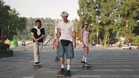 Group of Young Progressive Skaters in the City Park alt