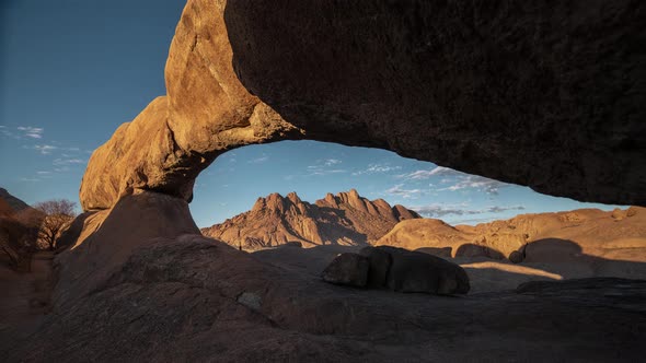 The Bridge, a natural arch formation in Spitzkoppe Namibia Southern Africa - Morning to dusk timelap alt