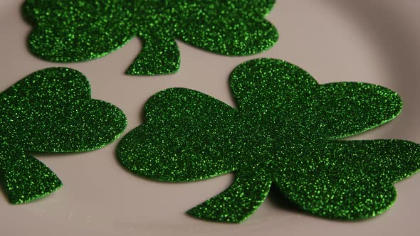 Rotating stock footage shot of St Patty's Day clovers on a white surface - ST PATTYS 008 alt
