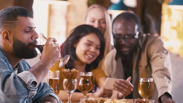 Stylish Arabian man drinking dark beer