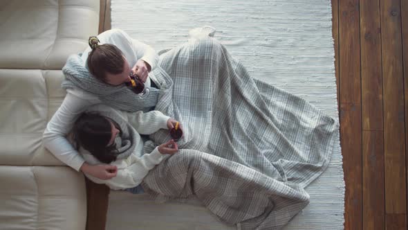 Winter Holidays a Couple of Young People Relax Lying on the Floor in a Country House Man and Young alt